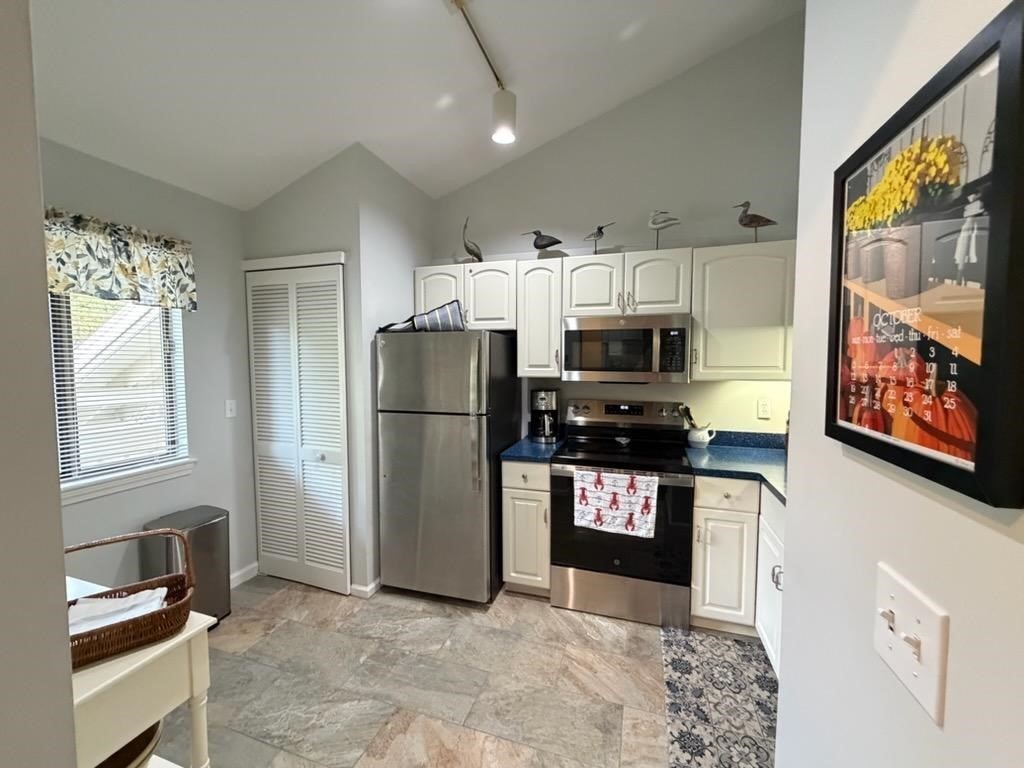 150 Eaton Lane, Unit 150 Brewster, MA 02631 - Photo 8 of 20 a kitchen with stainless steel appliances granite countertop a refrigerator stove and sink