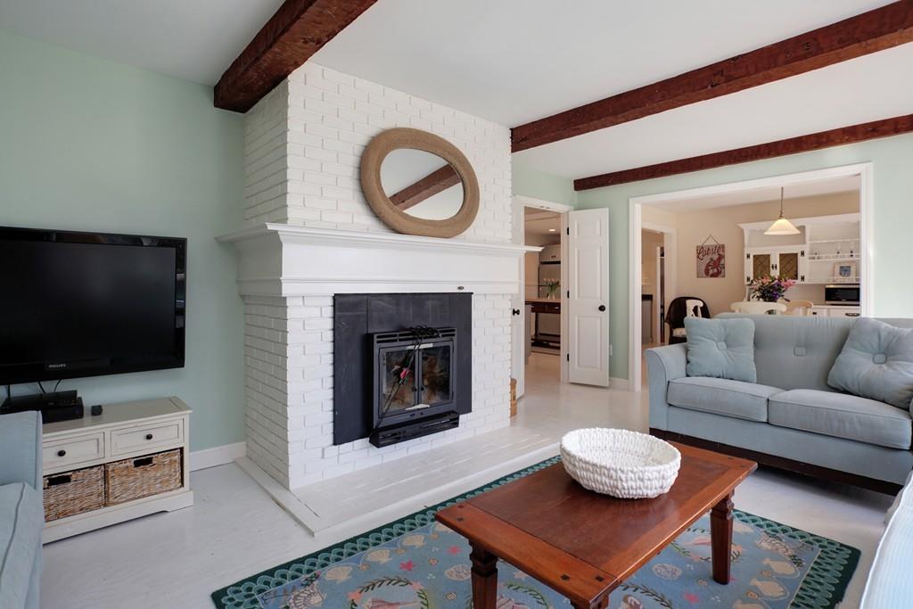 195 Crystal Lake Road Osterville, MA 02655 - Photo 13 of 36 a living room with furniture a flat screen tv and a fireplace