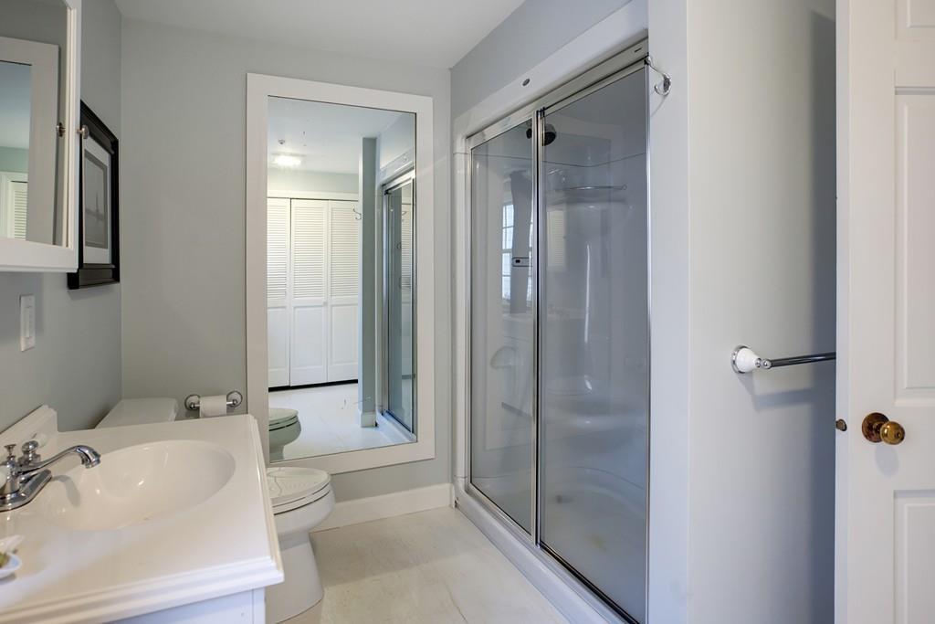 195 Crystal Lake Road Osterville, MA 02655 - Photo 15 of 36 a bathroom with a bathtub shower sink vanity and toilet