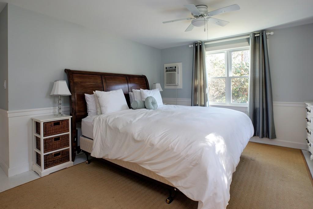 195 Crystal Lake Road Osterville, MA 02655 - Photo 22 of 36 a bed sitting in a bedroom next to a window