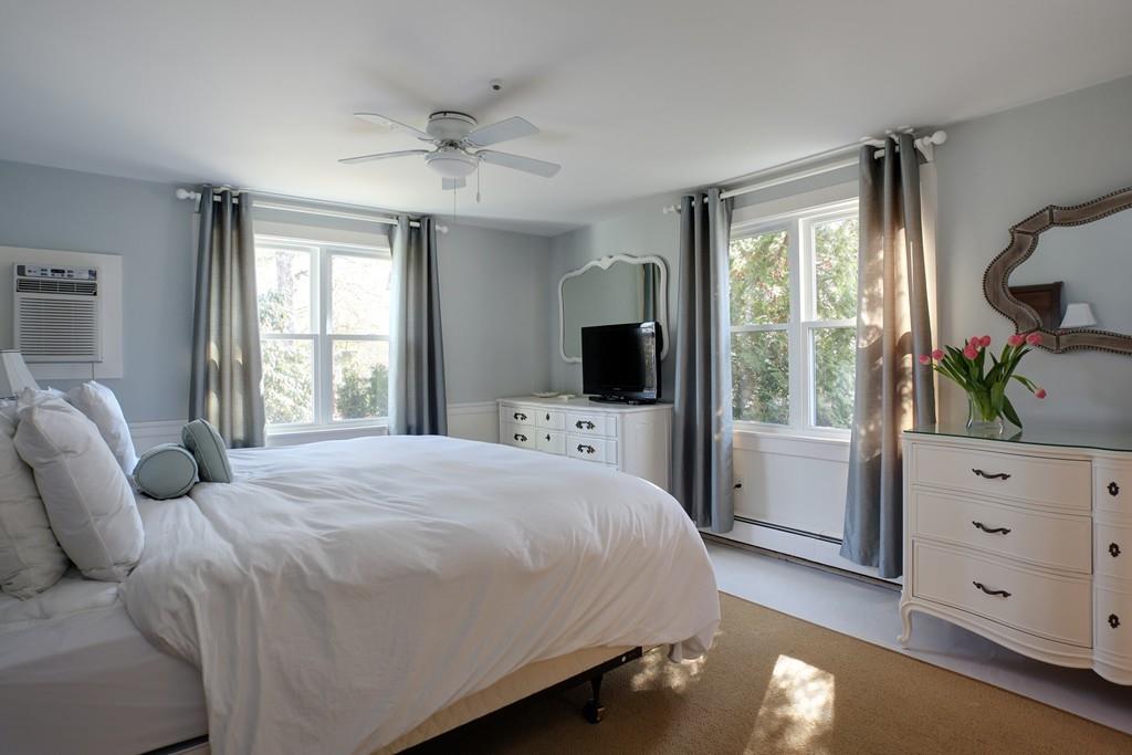 195 Crystal Lake Road Osterville, MA 02655 - Photo 23 of 36 a bedroom with a large bed and a window