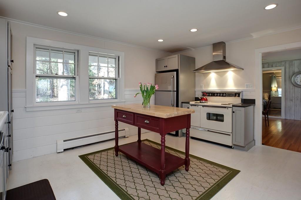 195 Crystal Lake Road Osterville, MA 02655 - Photo 4 of 36 a kitchen with stainless steel appliances granite countertop a stove a sink dishwasher and a refrigerator with wooden floor