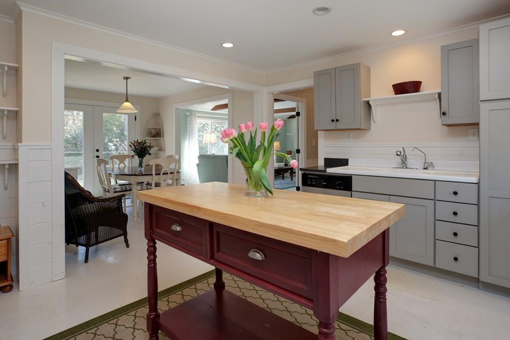 195 Crystal Lake Road Osterville, MA 02655 - Photo 6 of 36 a room with kitchen island a wooden floor and white cabinets