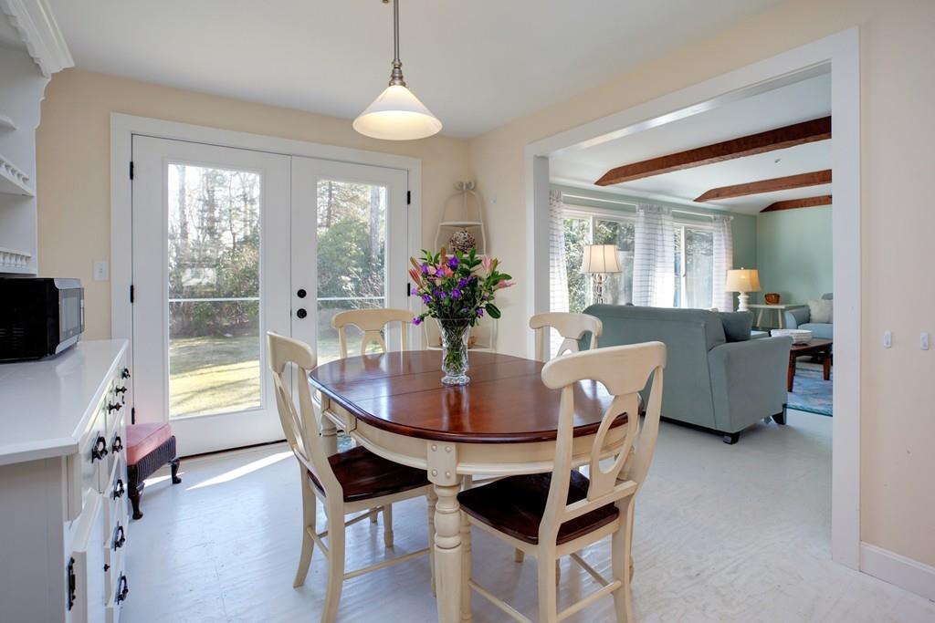 195 Crystal Lake Road Osterville, MA 02655 - Photo 9 of 36 a dining room with furniture potted plants and wooden floor