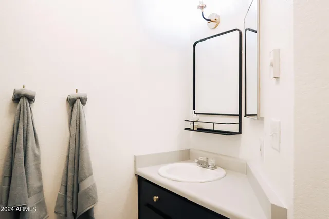 a bathroom with a sink vanity and a mirror