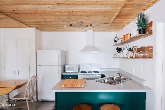 a room with furniture and a kitchen view