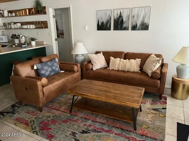 a living room with furniture and a rug