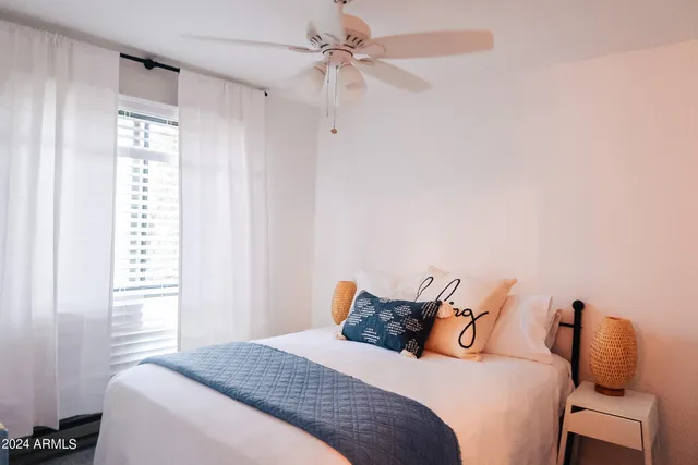 a bedroom with a bed and a window