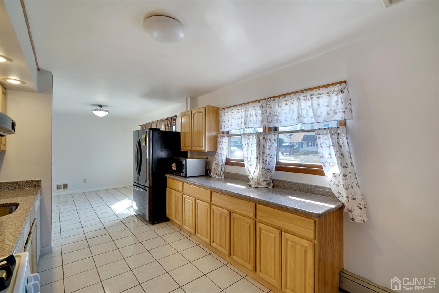 83 Winthrop Road Edison, NJ 08817 - Photo 14 of 36 a kitchen with stainless steel appliances granite countertop a sink and a refrigerator