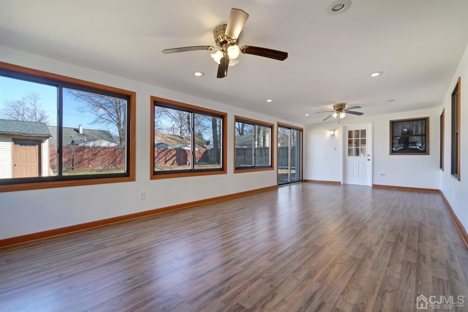 83 Winthrop Road Edison, NJ 08817 - Photo 23 of 36 a view of an empty room with a window and wooden floor