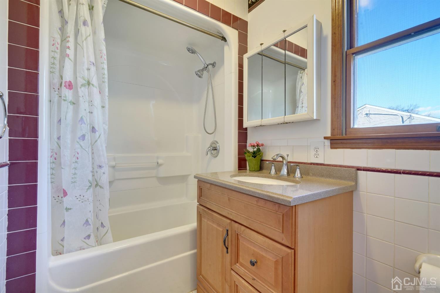 83 Winthrop Road Edison, NJ 08817 - Photo 29 of 36 a bathroom with a sink and a mirror