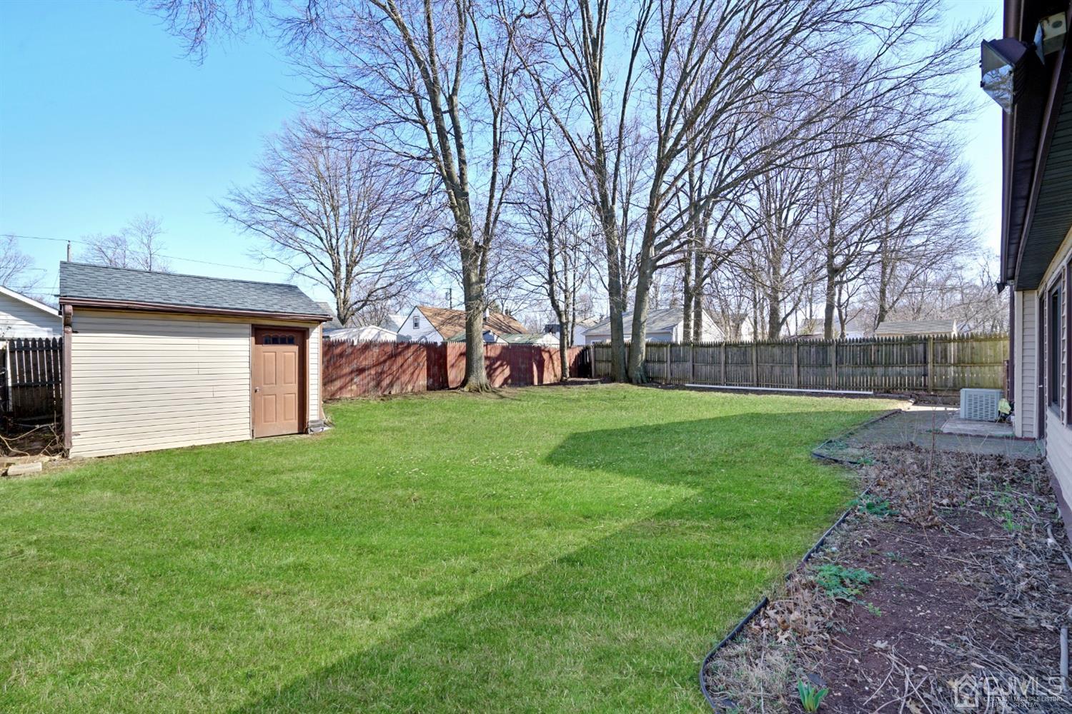 83 Winthrop Road Edison, NJ 08817 - Photo 10 of 36 a view of a yard with a house in the background