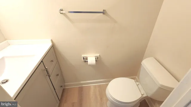 a bathroom with a toilet and a mirror
