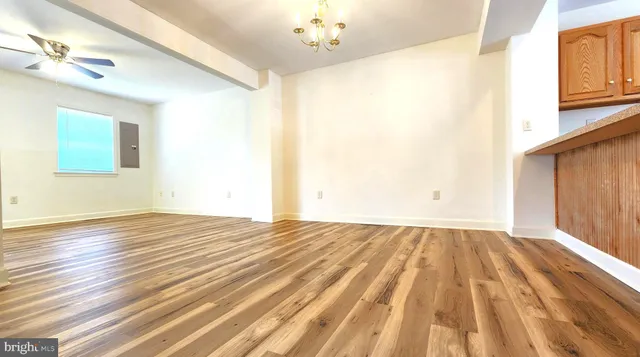 a view of empty room with wooden floor