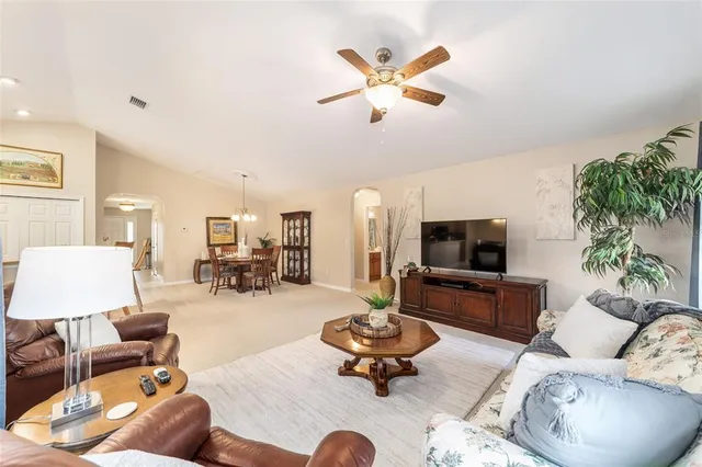 a view of a dining room with furniture and chandelier