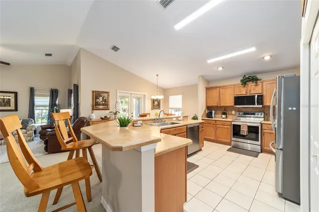 a kitchen with a sink stove and refrigerator