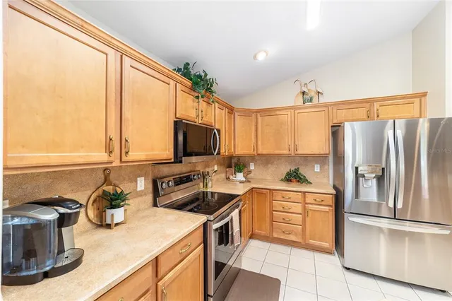 a large kitchen with stainless steel appliances lots of counter top space