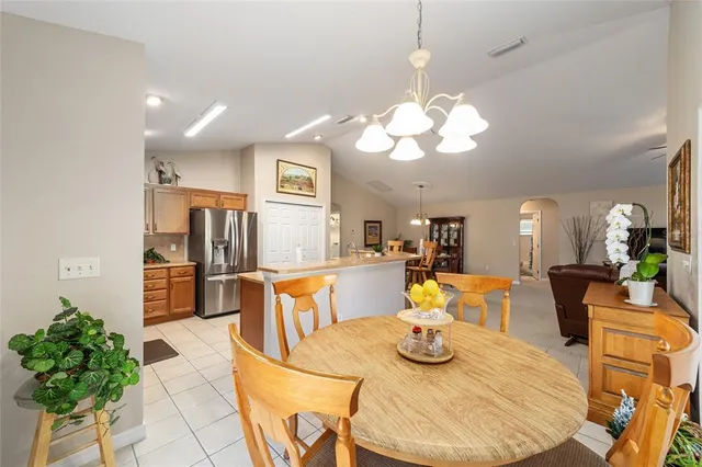 a bedroom with bed and a chandelier