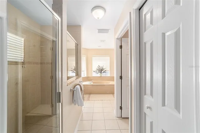 a bathroom with a bathtub a sink and a window