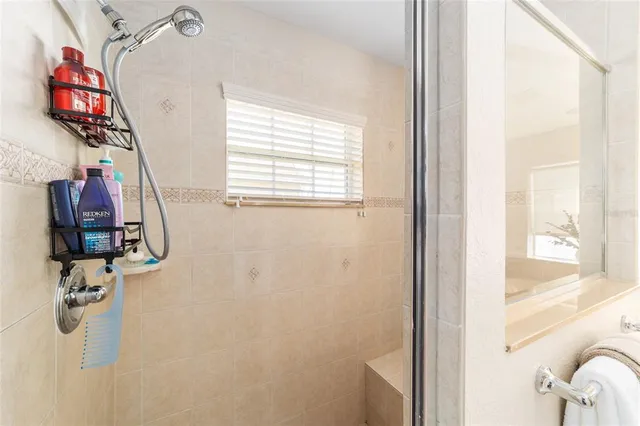 a bedroom with a bed and dresser with mirror