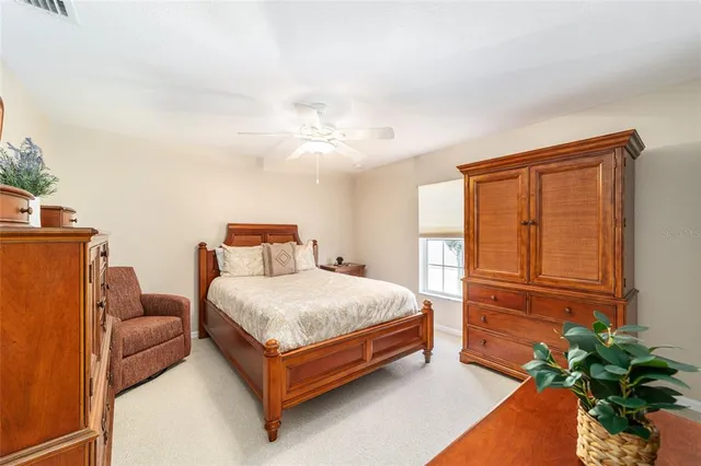 a dining room with furniture a chandelier and a large window
