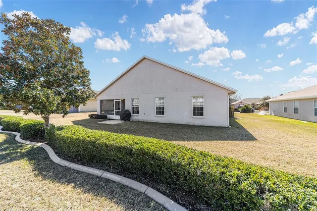 an aerial view of a house with garden space and ocean view
