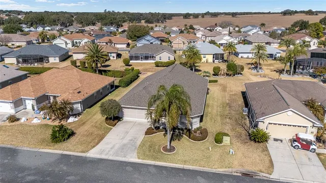an aerial view of a residential houses with outdoor space