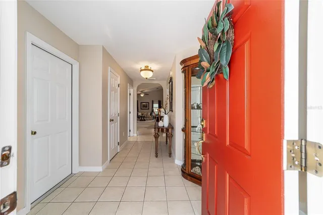 a living room with a couch and a table with potted plants