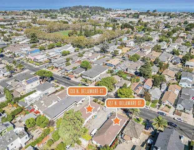 an aerial view of residential houses with outdoor space