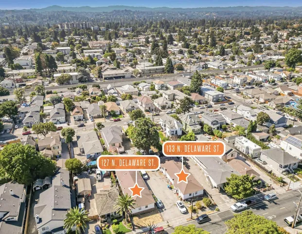 an aerial view of residential houses with outdoor space