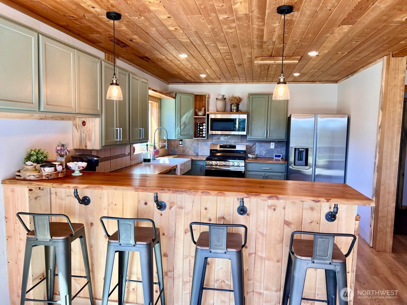 3705 Hope Way Kettle Falls, WA 99141 - Photo 13 of 37 a kitchen with stainless steel appliances granite countertop a sink and a refrigerator