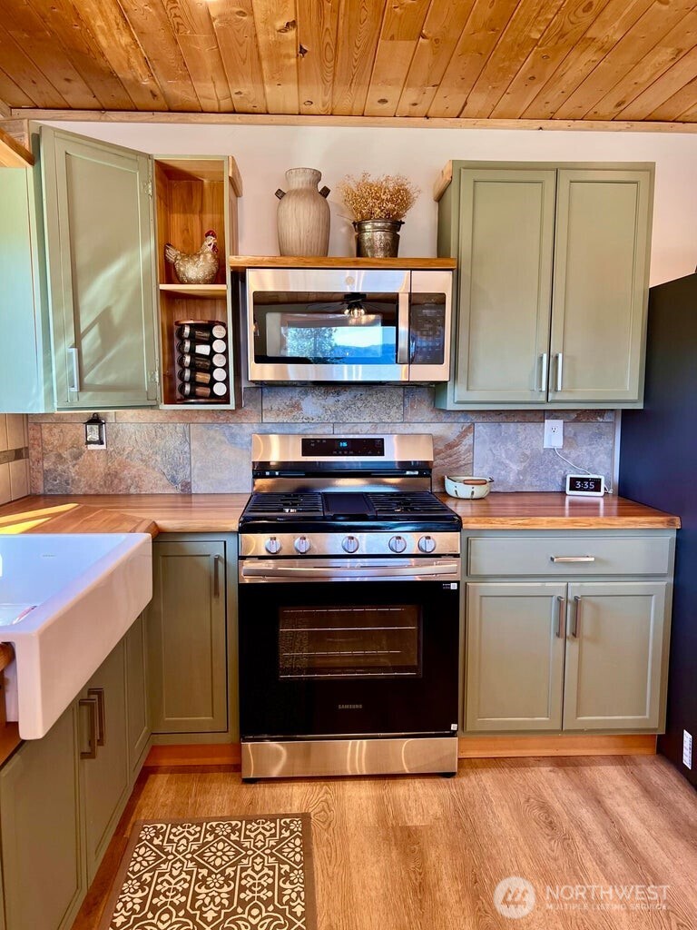 3705 Hope Way Kettle Falls, WA 99141 - Photo 14 of 37 a kitchen with stainless steel appliances granite countertop a stove and a sink