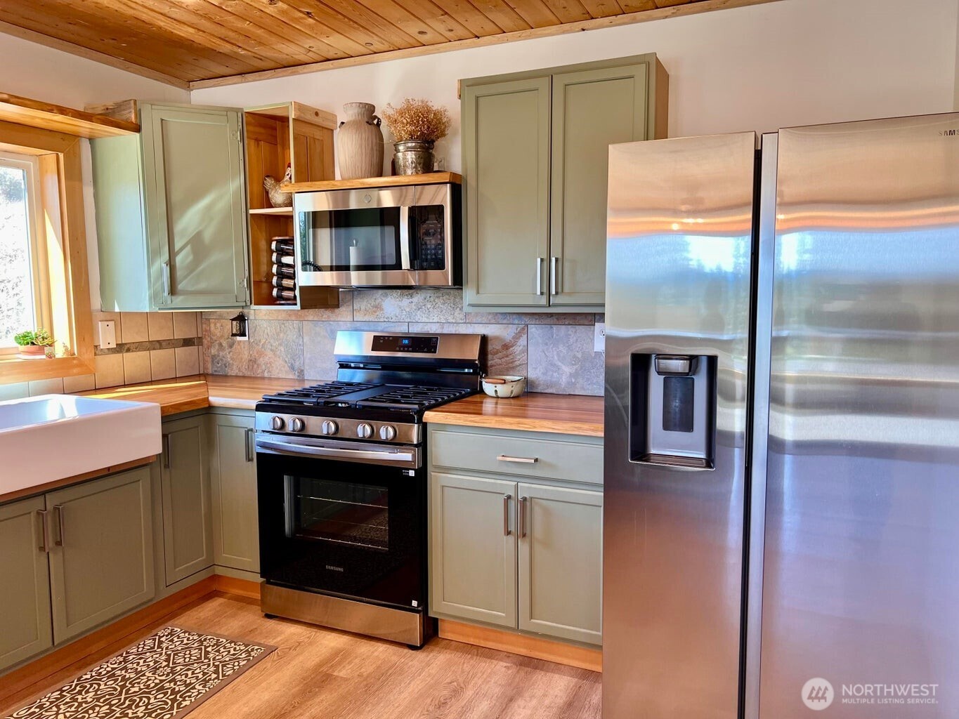 3705 Hope Way Kettle Falls, WA 99141 - Photo 15 of 37 a kitchen with stainless steel appliances granite countertop a stove a sink and a refrigerator