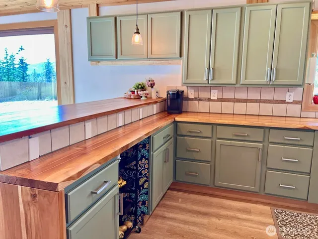 a kitchen with stainless steel appliances granite countertop a sink and cabinets