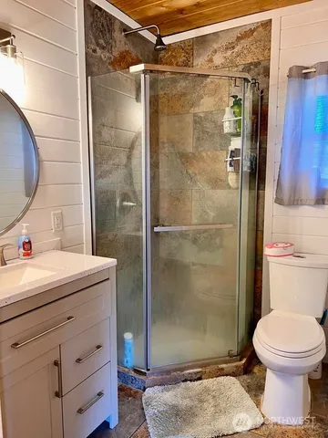 a bathroom with a sink toilet and shower