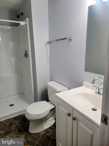a white toilet sitting next to a bathroom sink