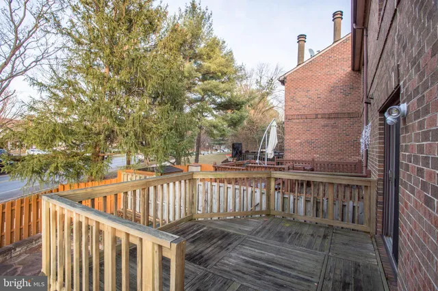 a balcony with wooden floor and fence
