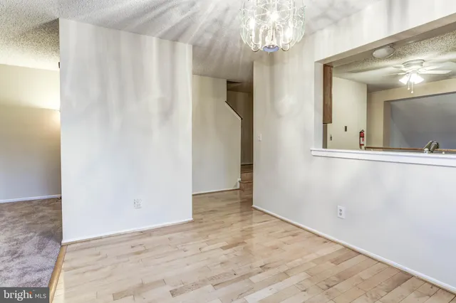 a view of an empty room with a mirror