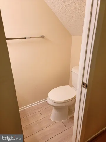a bathroom with a white toilet and a shower