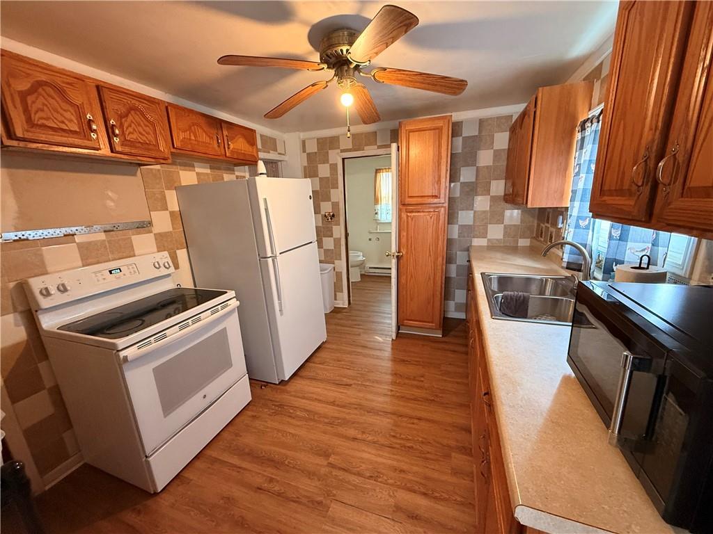 302 West Boyd Avenue Butler, PA 16001 - Photo 11 of 19 a kitchen with a refrigerator a stove top oven a sink and wooden floor
