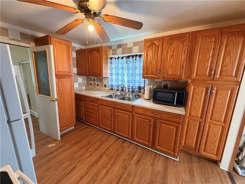 302 West Boyd Avenue Butler, PA 16001 - Photo 10 of 19 a kitchen with stainless steel appliances wooden floors and a refrigerator