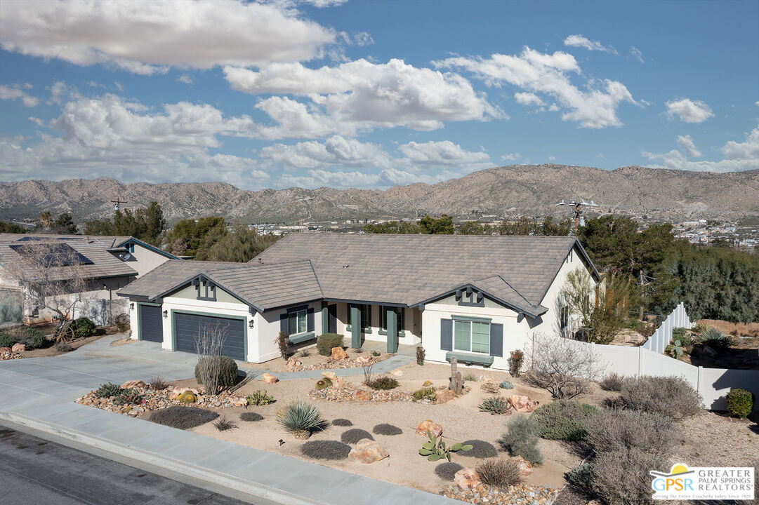 56166 Nez Perce Trail Yucca Valley, CA 92284 - Photo 2 of 54 a view of a house with a snow in the middle of the middle