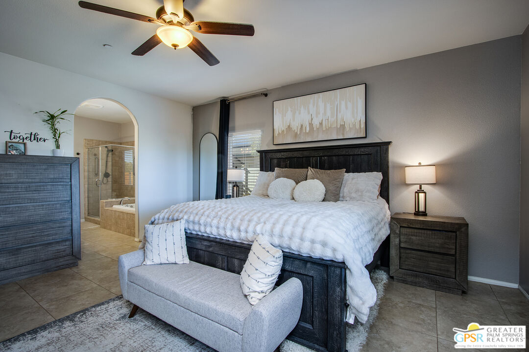 56166 Nez Perce Trail Yucca Valley, CA 92284 - Photo 24 of 54 a bedroom with a bed and wooden floor