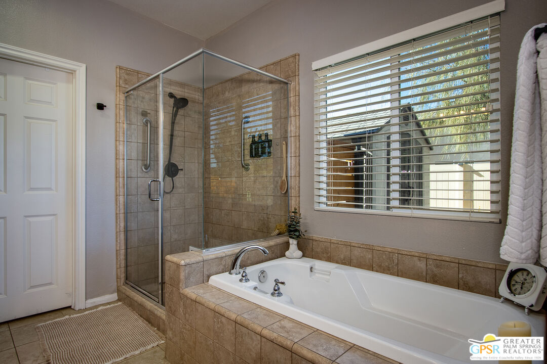 56166 Nez Perce Trail Yucca Valley, CA 92284 - Photo 26 of 54 a bathroom with a tub a sink a mirror and a shower