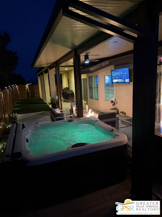 56166 Nez Perce Trail Yucca Valley, CA 92284 - Photo 3 of 54 a view of a backyard with a patio and a fireplace