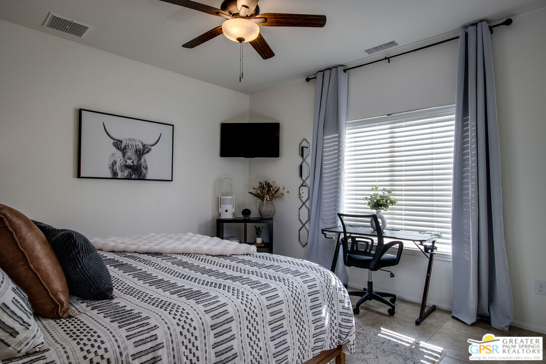 56166 Nez Perce Trail Yucca Valley, CA 92284 - Photo 31 of 54 a bedroom that has a bed and a flat screen tv