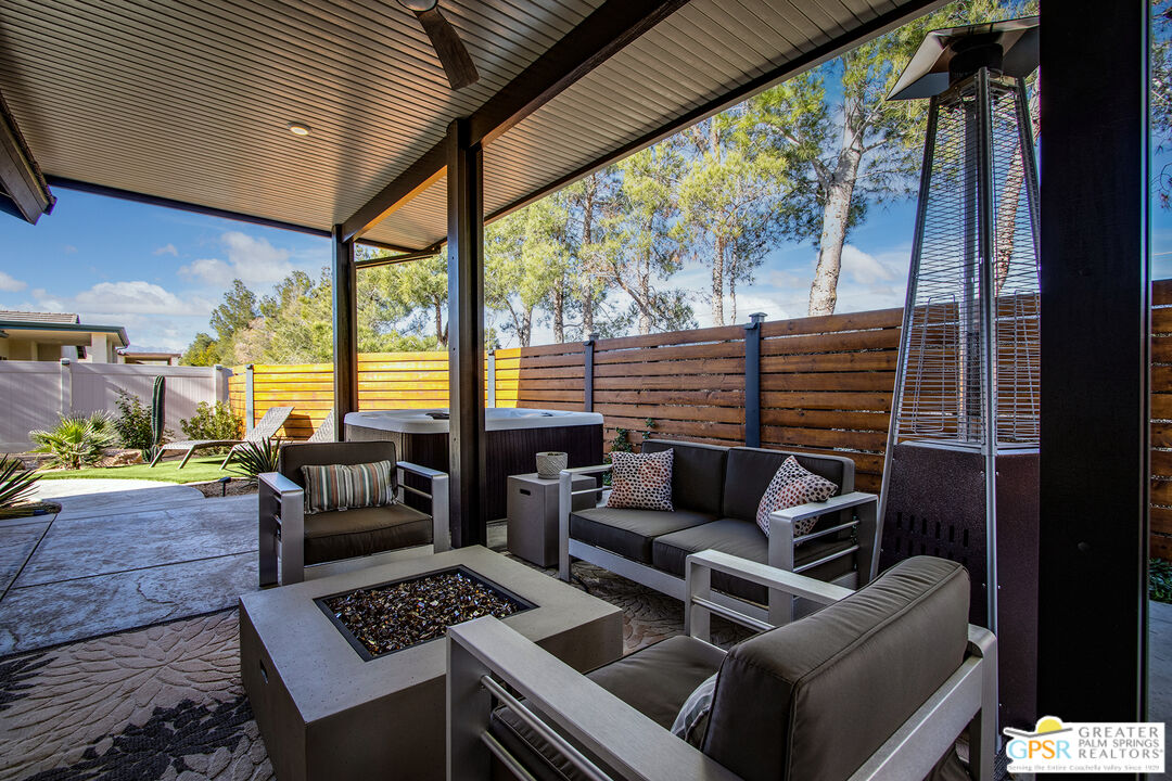56166 Nez Perce Trail Yucca Valley, CA 92284 - Photo 39 of 54 a living room with furniture and a floor to ceiling window