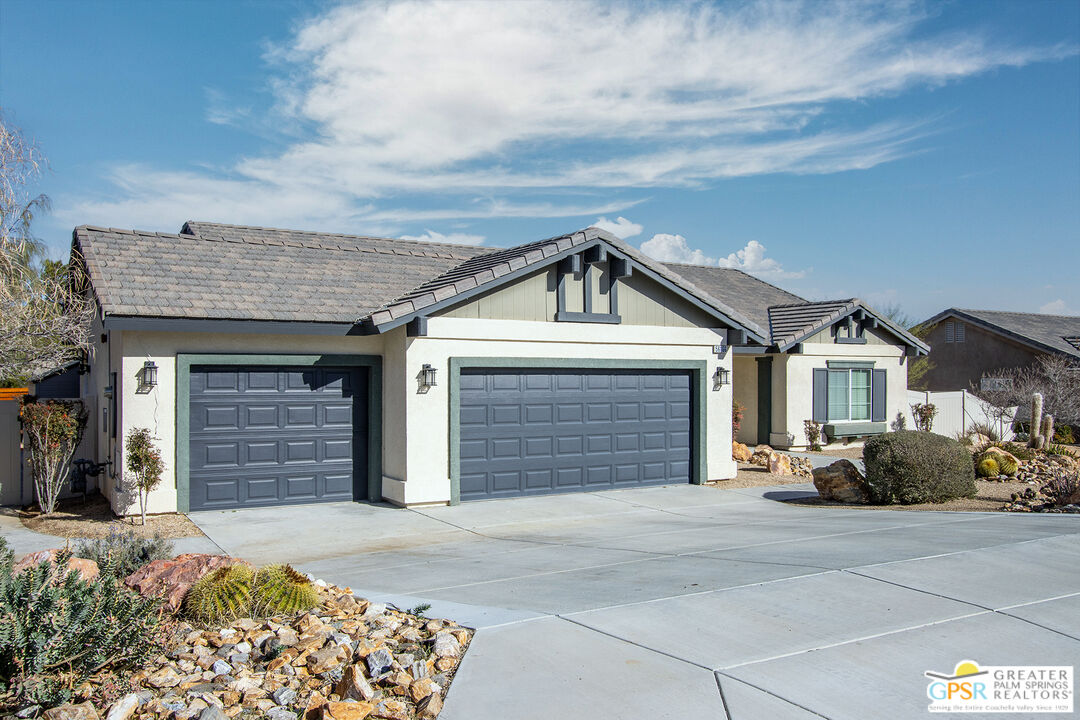56166 Nez Perce Trail Yucca Valley, CA 92284 - Photo 48 of 54 a front view of a house with a yard and garage