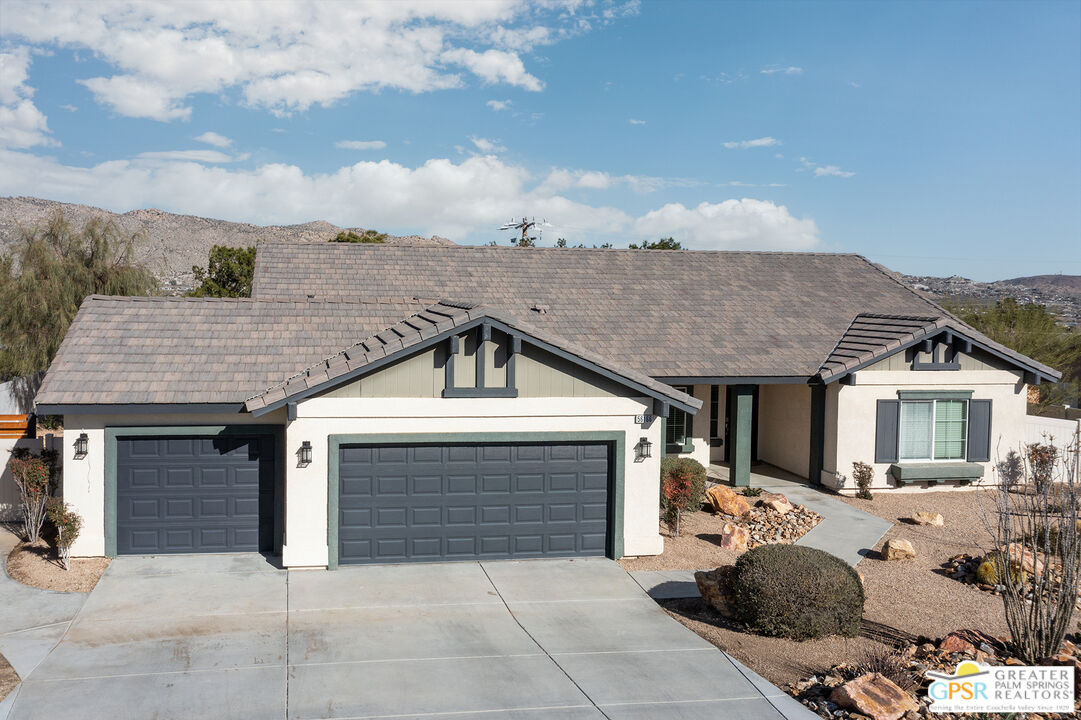 56166 Nez Perce Trail Yucca Valley, CA 92284 - Photo 49 of 54 a front view of a house with a yard and garage