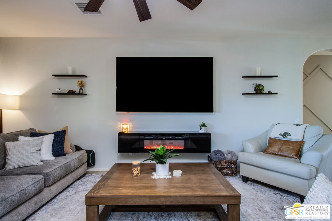 56166 Nez Perce Trail Yucca Valley, CA 92284 - Photo 9 of 54 a living room with furniture and a flat screen tv